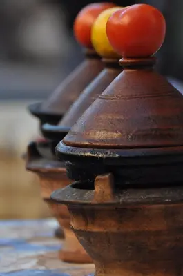 a row of wooden bowls with tomatoes on top at Riad Louaya in Marrakech