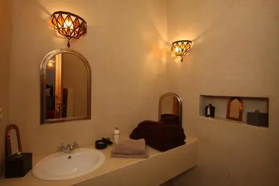 a bathroom with a sink and two mirrors at Riad Mariana in Marrakech