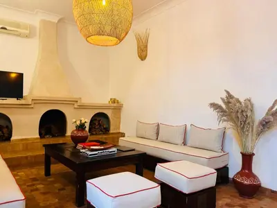 a living room with a couch and a fireplace at Riad Bamaga in Marrakech