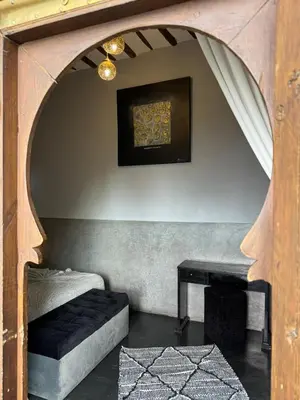 a room with a bed and a table at Riad Des Arts in Marrakech