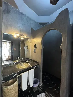a bathroom with a sink and a mirror at Riad Des Arts in Marrakech