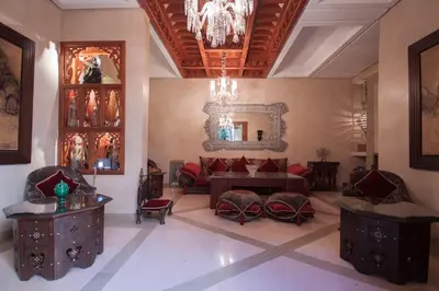 a living room with a couch and a mirror at Riad Flam & Spa in Marrakech