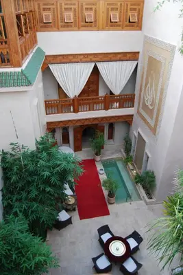 an overhead view of a courtyard with a pool and a red carpet at Riad Flam & Spa in Marrakech