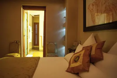 a bedroom with a white bed with two pillows at Riad Flam & Spa in Marrakech