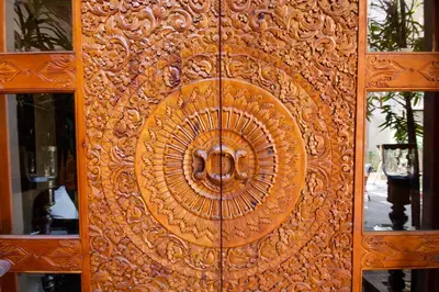 a wooden door with a circular design on it at Riad Flam & Spa in Marrakech