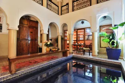 an indoor swimming pool in a house with a swimming pool at Riad Chalymar in Marrakech