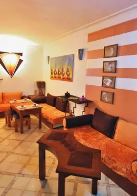 a living room with couches and a table at Riad Chalymar in Marrakech