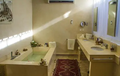 a large bathroom with a tub and a sink at Palais El Miria & SPA in Dar Caïd Layadi