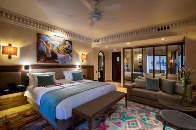 a bedroom with a large bed and a couch at Les Jardins De La Koutoubia in Marrakech