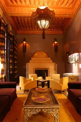 a living room with couches and a fireplace at Les Jardins De La Koutoubia in Marrakech