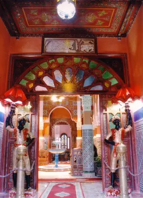 a room with two statues in front of a building at Moroccan House in Marrakech
