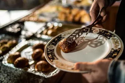a person holding a plate with a fork and a dessert at Moroccan House in Marrakech