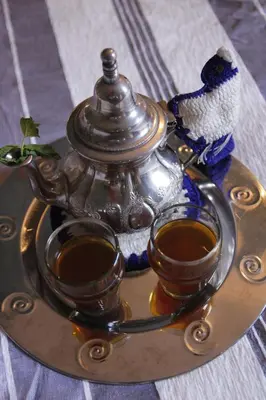 a tea pot and two cups on a tray at Riad Azenzer in Marrakech
