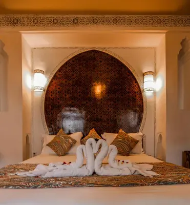 a bed with two people made out of towels at Riad Anya & SPA in Marrakech