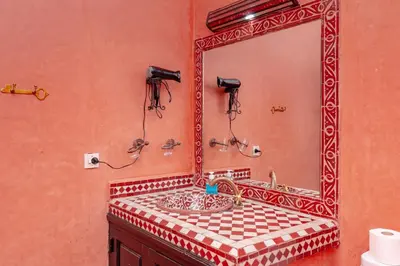 a bathroom with a mirror and a sink at Riad Losra in Marrakech
