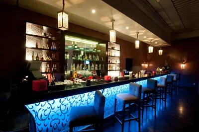 a bar with a row of blue bar stools at Palm Plaza Marrakech in Marrakech