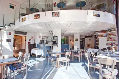 a restaurant with tables and chairs in a room at Amani Hotel Suites & Spa in Marrakech