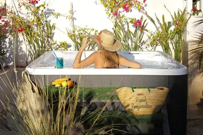 a woman in a bath tub with a hat at Riad Anyssates in Marrakech