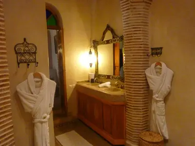 a bathroom with a sink and a mirror at Riad Les Trois Palmiers El Bacha in Marrakech