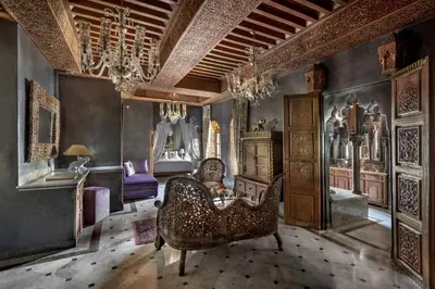 a living room with a couch and a chair at La Sultana Marrakech in Marrakech