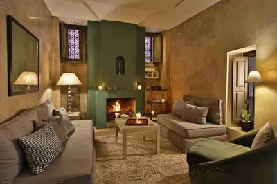 a living room with a couch and a fireplace at Riad Dar One in Marrakech