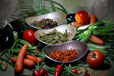 three bowls filled with vegetables on a table at Riad Dar One in Marrakech