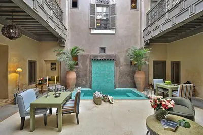 a living room with a swimming pool in a building at Riad Dar One in Marrakech
