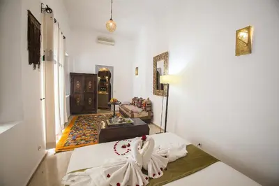 a living room with a bed in a room at Riad De Vinci & SPA in Marrakech