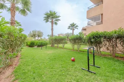 a field with a soccer ball in the grass at Résidence Golfique PJ, jardin, piscine in Marrakech