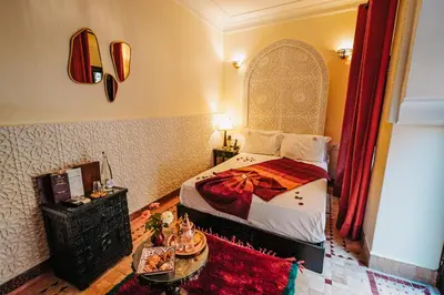 a bedroom with a bed and a table in a room at Les Borjs De La Kasbah in Marrakech