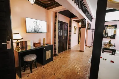 a hallway with a table and a chair in a room at Les Borjs De La Kasbah in Marrakech