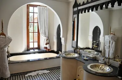 a bathroom with two sinks and a bath tub at Demeures d'Orient Riad & Spa in Marrakech