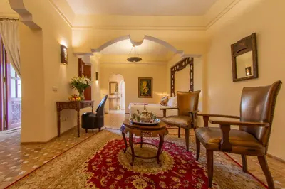 a living room with a couch and a table at Demeures d'Orient Riad & Spa in Marrakech