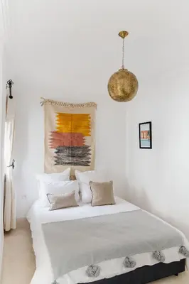 a white bedroom with a bed with white sheets at Riad 27 & SPA entièrement privatisé in Marrakech