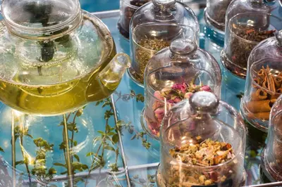a group of glass jars with flowers in them at Es Saadi Marrakech Resort - Palace in Marrakech