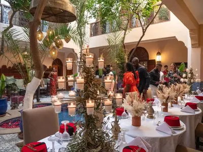 a banquet hall with tables with candles and plants at Riad Dar El Médina - Heated Swimming pool, jacuzzi & Spa in Marrakech