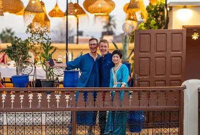 a group of three people standing on a fence at Riad Dar El Médina - Heated Swimming pool, jacuzzi & Spa in Marrakech