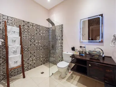 a bathroom with a toilet and a sink and a shower at Riad Dar El Médina - Heated Swimming pool, jacuzzi & Spa in Marrakech