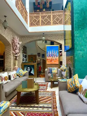 a large living room with couches and a fireplace at RIAD LUXE LOCATION le GRIZZLY in Marrakech