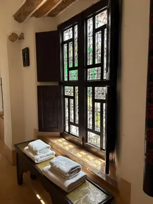 a room with a table with folded towels on a window at Riad Dar Balthazar in Marrakech