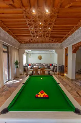 a pool table in the middle of a living room at Villa Dahlia in Marrakech