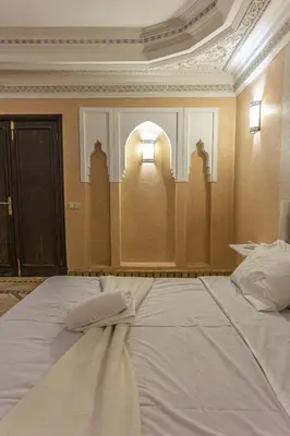 a bedroom with a large white bed with a window at Villa Dahlia in Marrakech