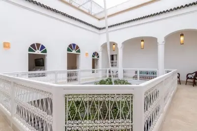 a white room with a white railing and a balcony at DAR SAFIRA in Marrakech
