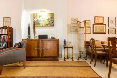 a living room with a wooden cabinet and a table at DAR SAFIRA in Marrakech