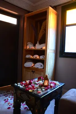 a room with a table with flowers on it at Riad Bab Nour in Marrakech
