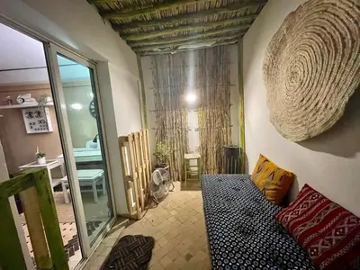 a living room with a couch and a mirror at Au Riad des Deux Patios - Marrakech in Marrakech