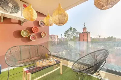 a room with two chairs and a table and a large window at Design, résidence standing, Salon modern, Terrasse in Marrakech