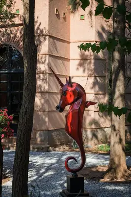 a statue of a horse head in front of a building at Villa Al Assala Palmeraie in Marrakech