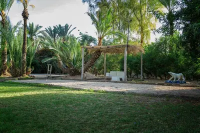 a park with a bench and a gazebo at Villa Al Assala Palmeraie in Marrakech