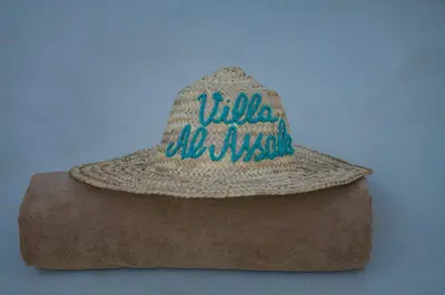 a straw hat sitting on top of a pillow at Villa Al Assala Palmeraie in Marrakech
